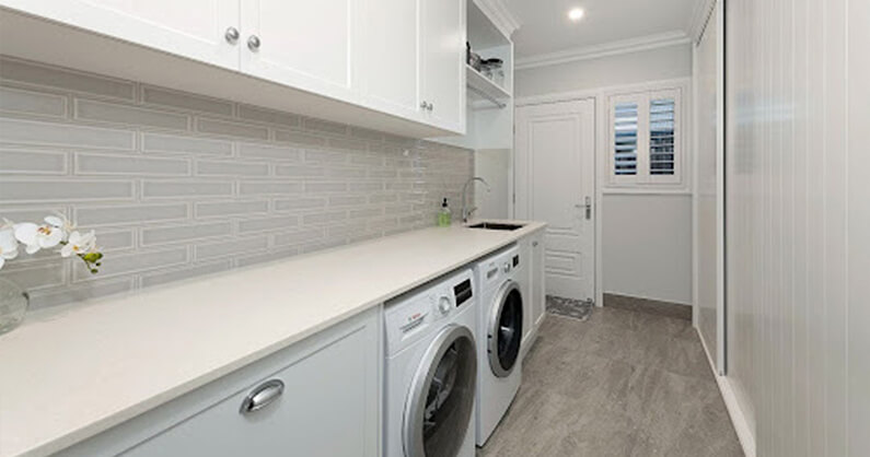 Tidy laundry room with long counter