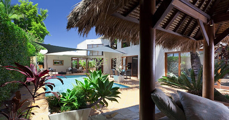 Tropical pool cabana with thatched roof