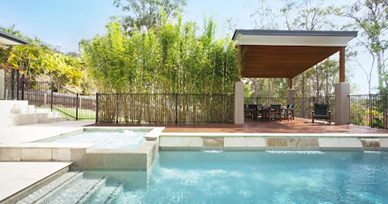 Pool cabana by hot tub and pool